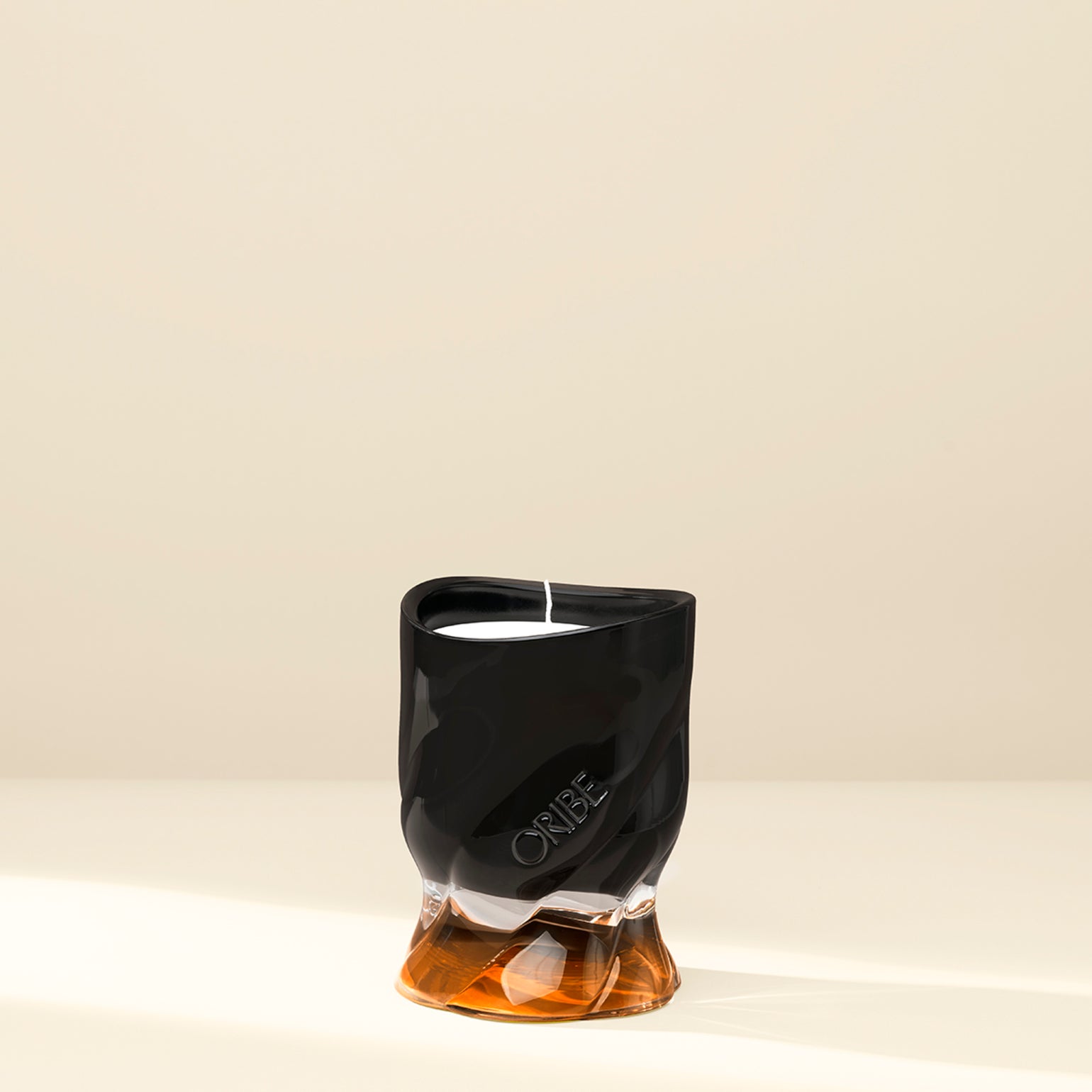 Black Oribe candle against a white background.