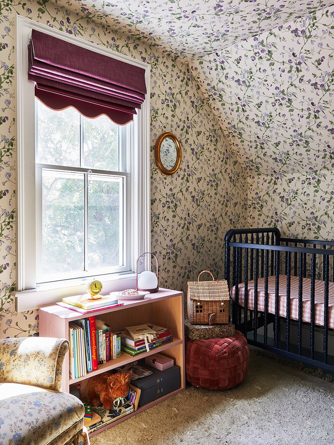 Kids room with crib and floral wallpaper