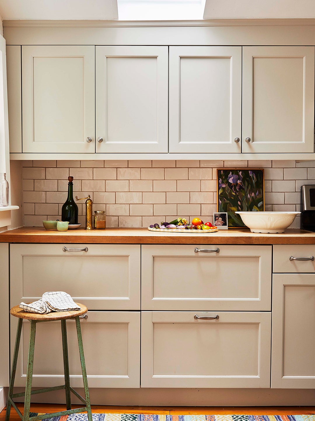 Beige kitchen cabinets and white subway tile