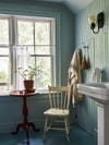 Light blue bathroom with chair
