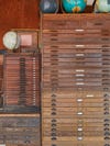 Close-up of two wooden flat files, with several globes resting atop them.