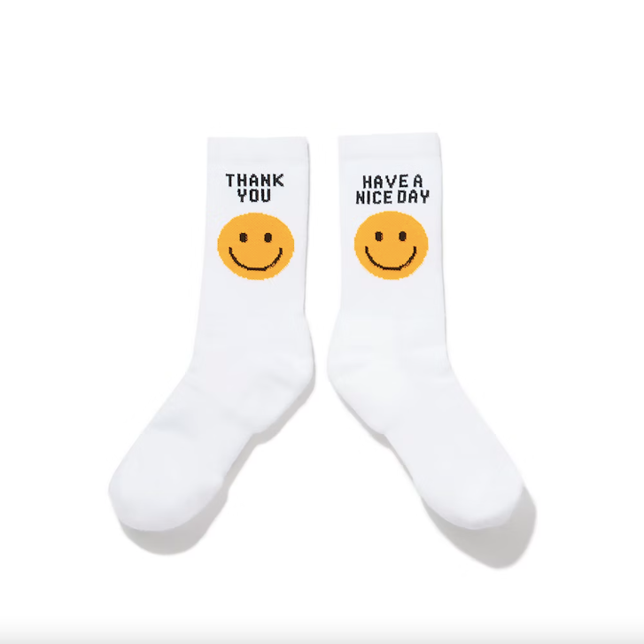 White socks with yellow smiley faces against a white background.