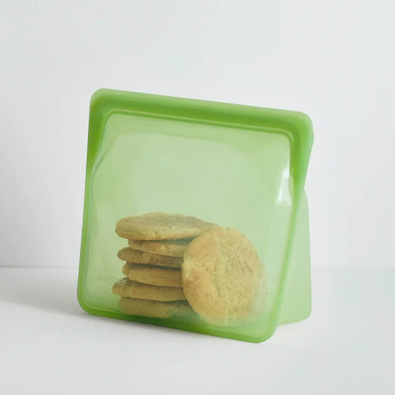 Snickerdoodle cookies inside a green Stasher mega bag on a white background.