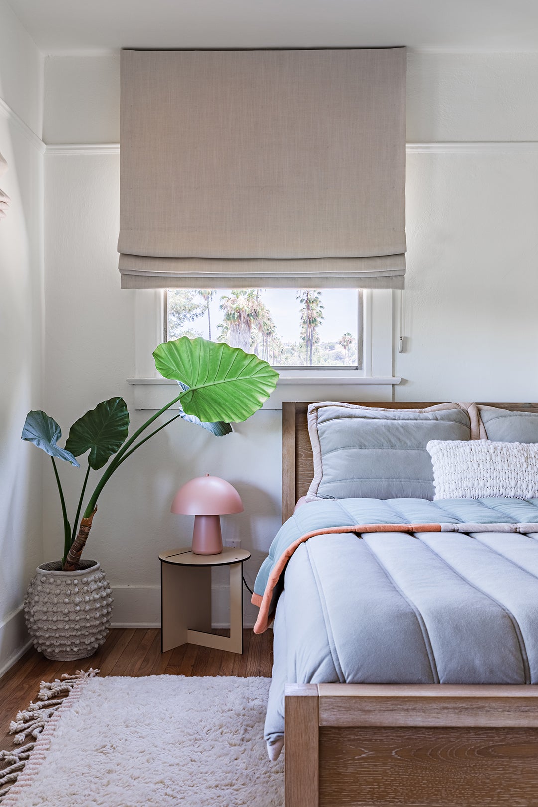 Guest bedroom with plant and mushroom lamp