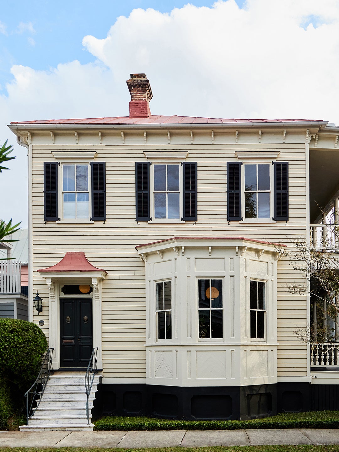 Clapboard Charleston home with bay window