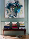 abstract painting above bench with books