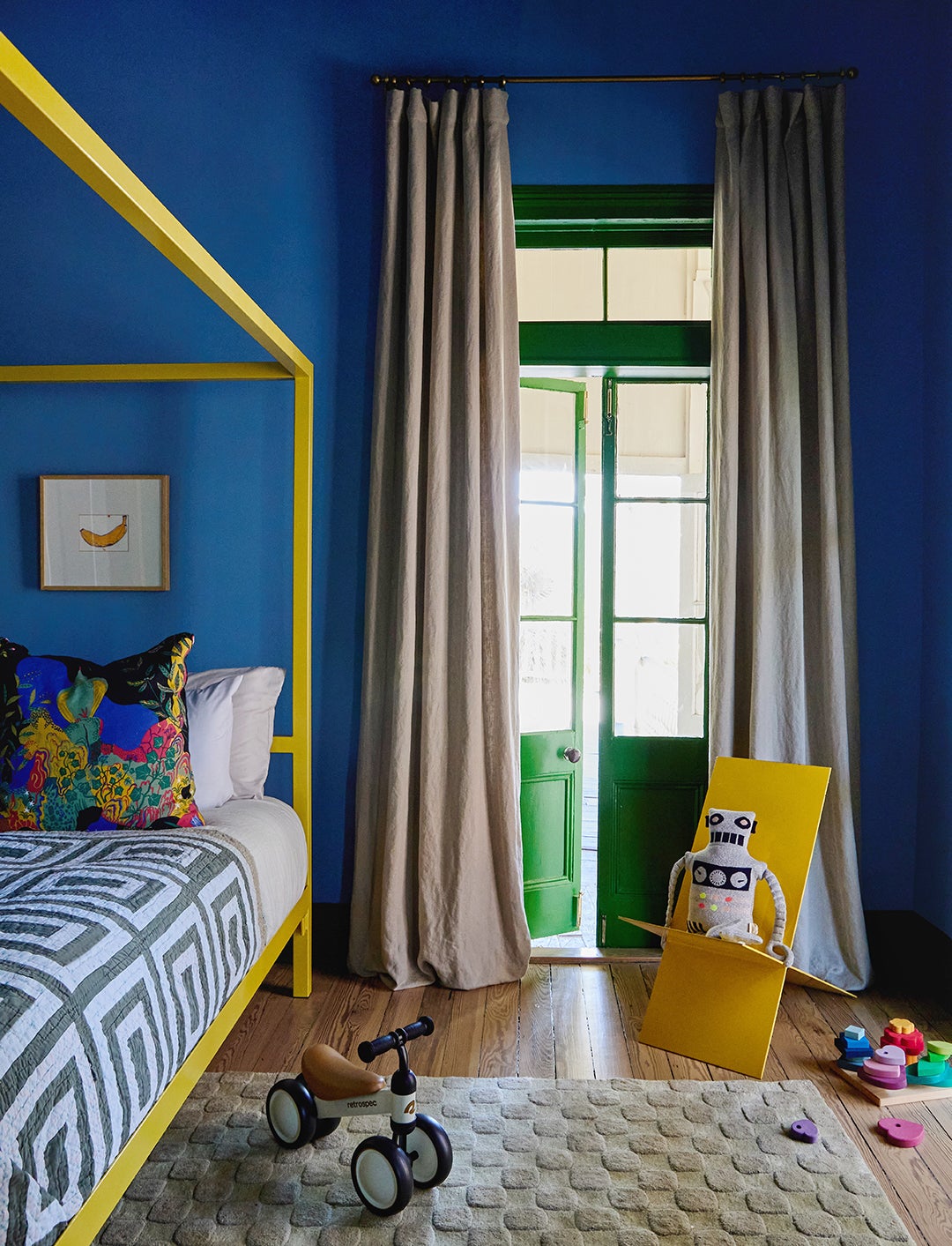 yellow canopy bed in blue and green nursery