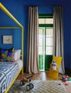 yellow canopy bed in blue and green nursery