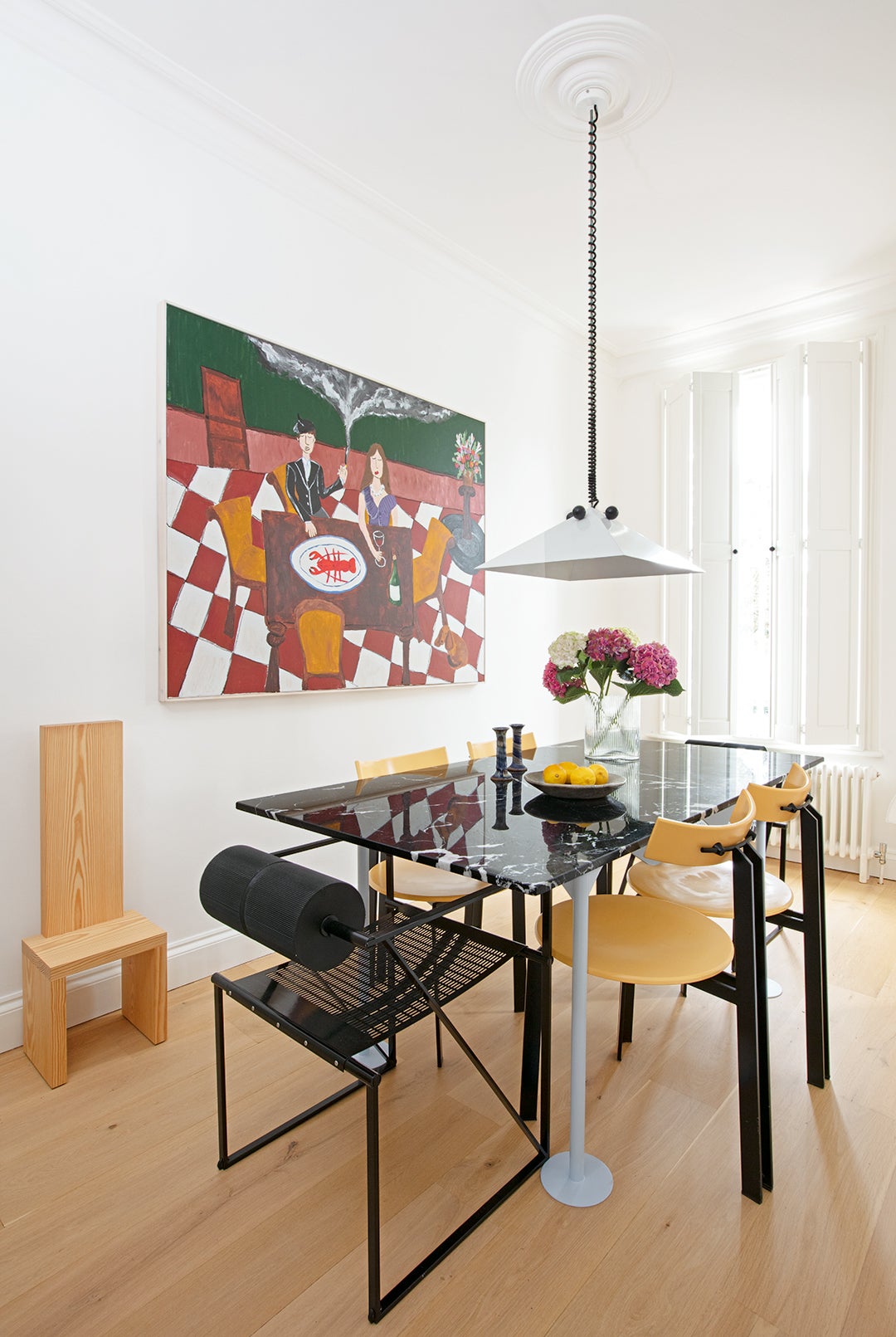 Dining room with pendant lamp and large art