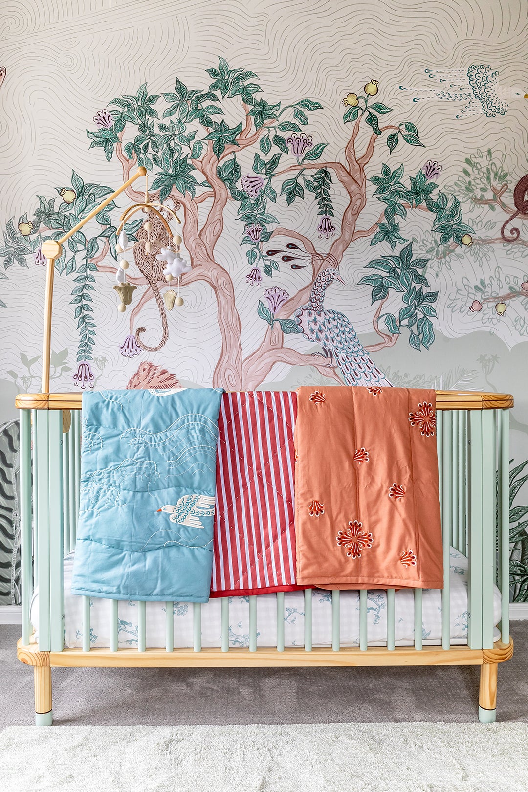quilts draped over crib