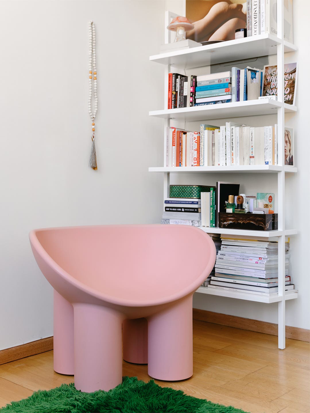 Pink chair in front of a bookcase