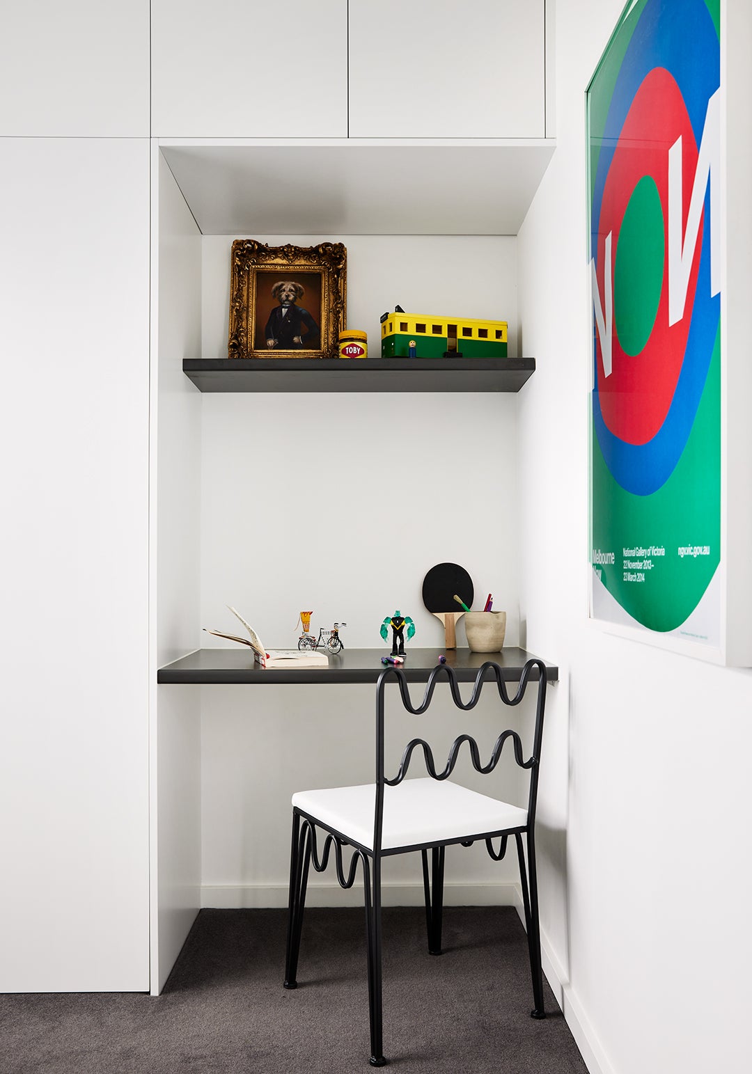 Rachel donath wave chair in front of black shelves in boy's bedroom 