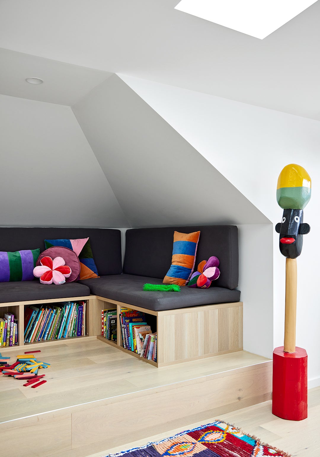 closer shot of kids room with bespoke wooden bookshelves and benches 