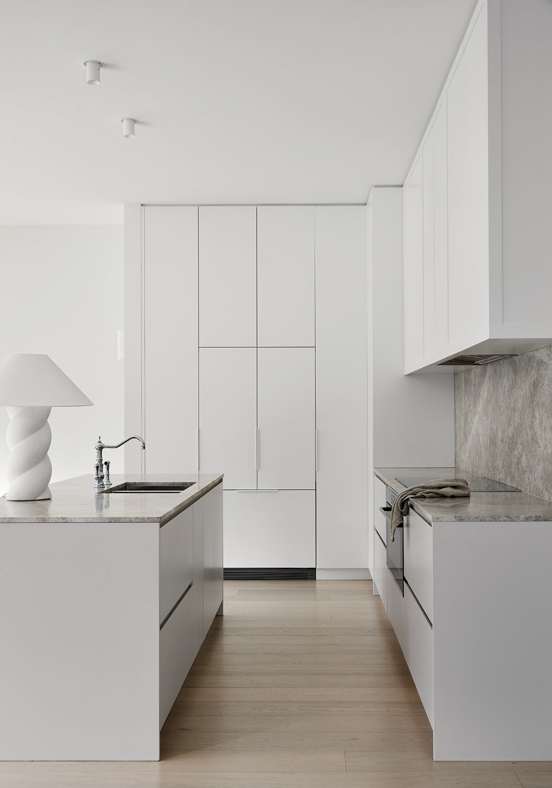white, minimalist kitchen with gray marble counters