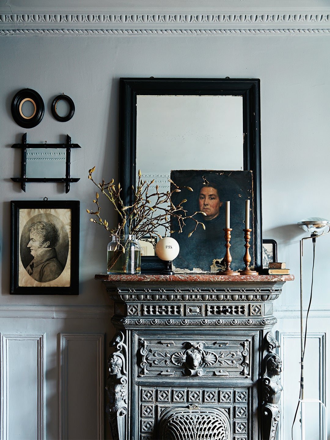 Mantel with a mirror, portrait, and candlesticks