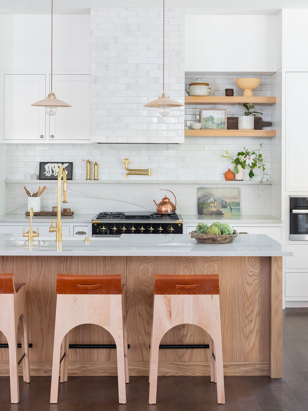 Kitchen with white tile and leather barstools