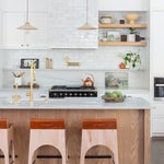 Kitchen with white tile and leather barstools