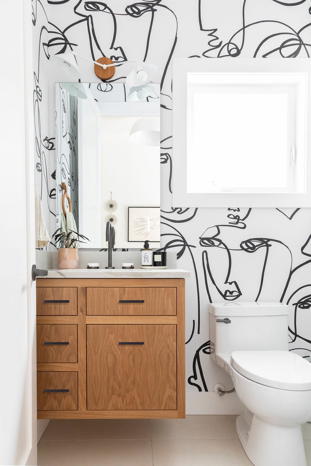 Powder room with face wallpaper