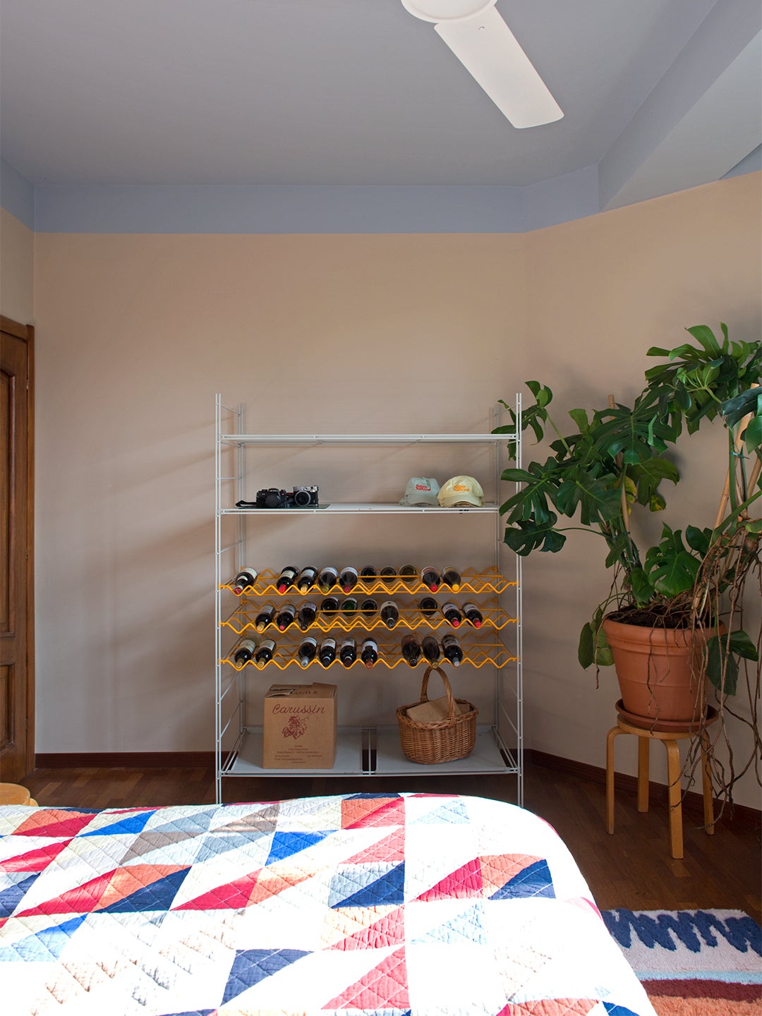 peach bedroom with wine rack storage unit