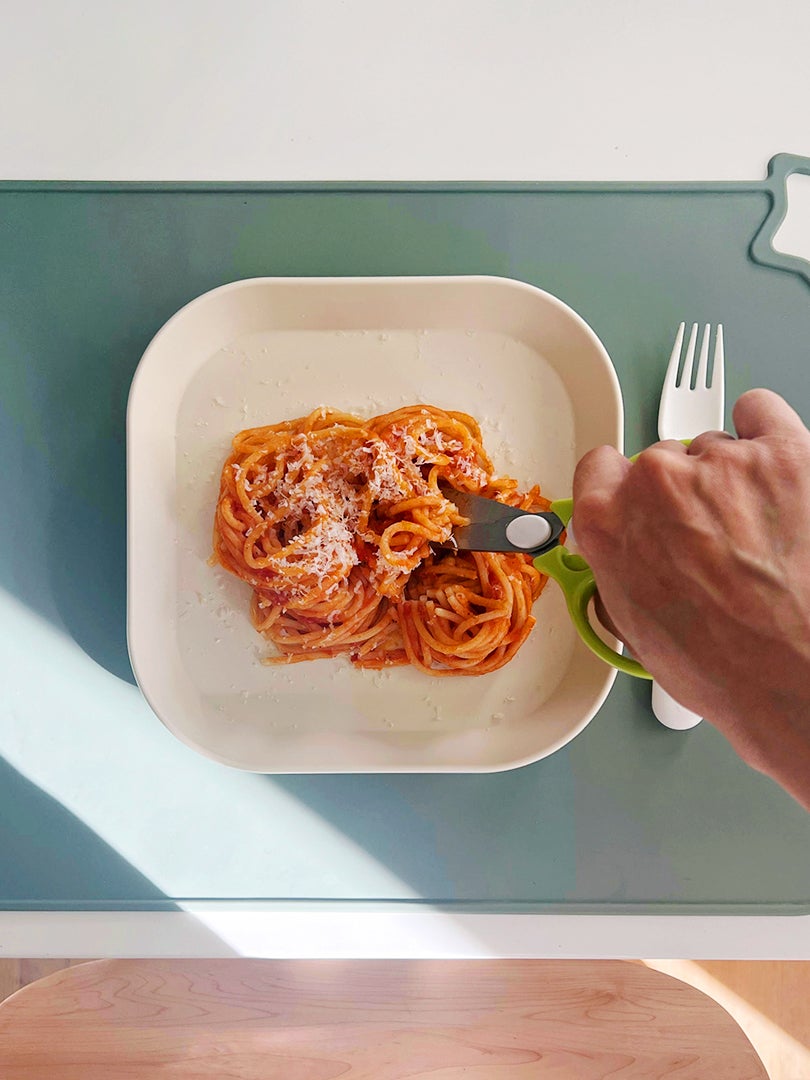 mini scissors cutting up spaghetti