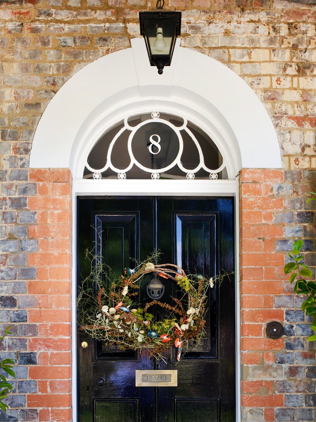 A front door with a holiday wreath