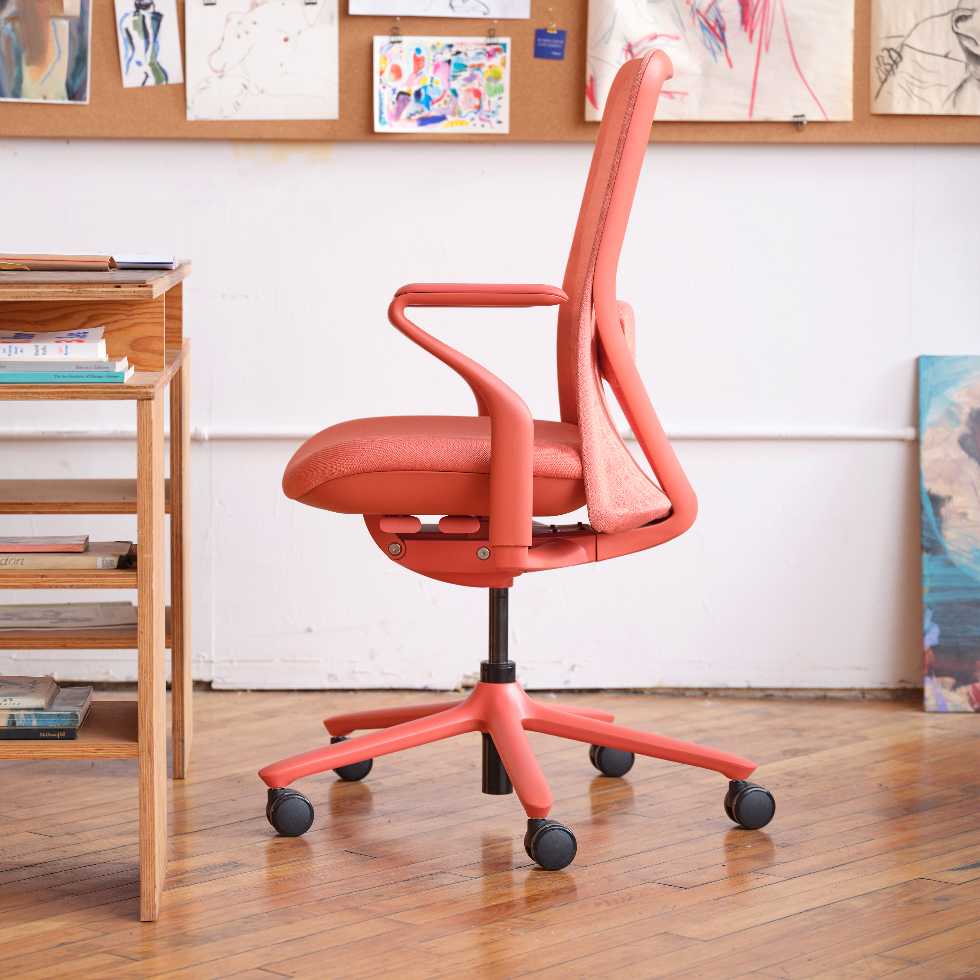 Coral-colored office chair turned to the side. 