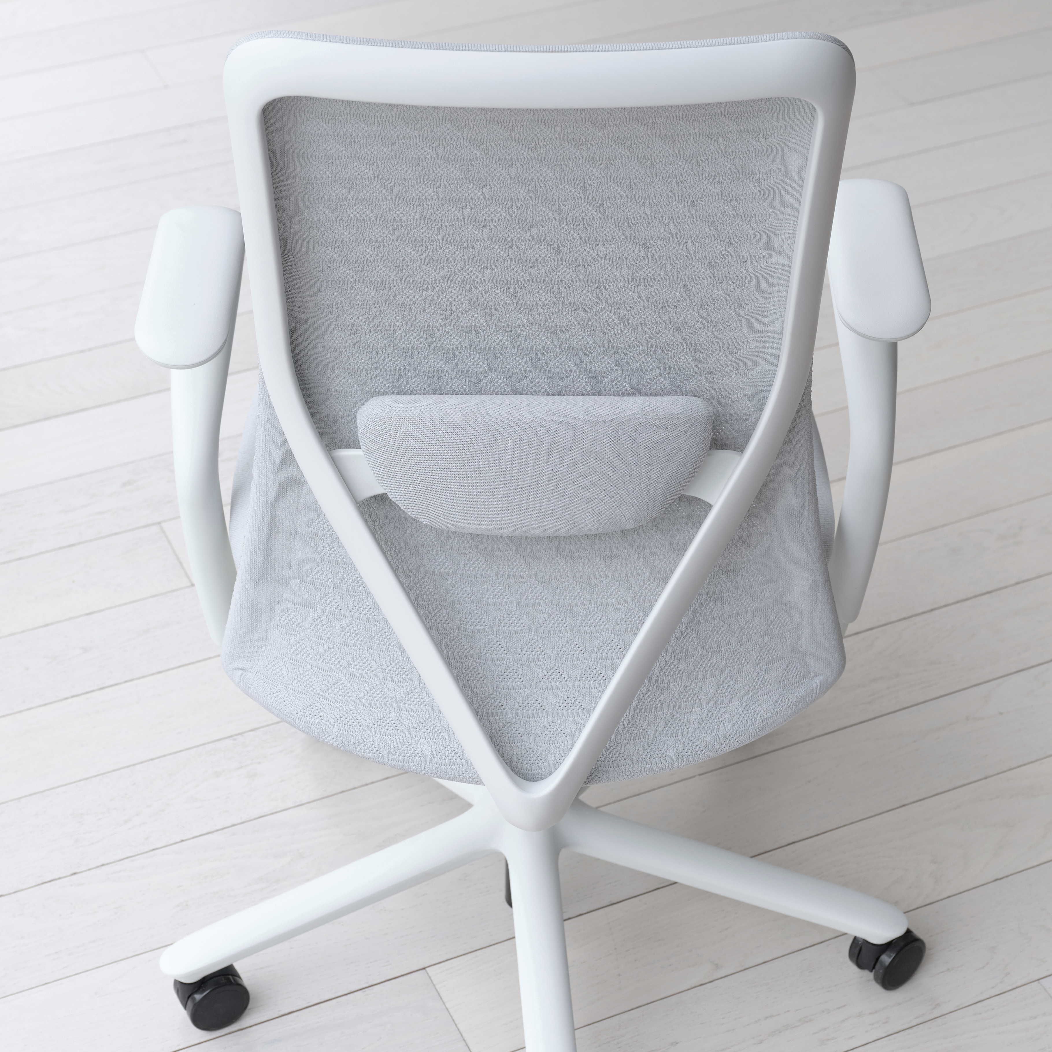 The mesh back of the light grey-colored Verve Chair.