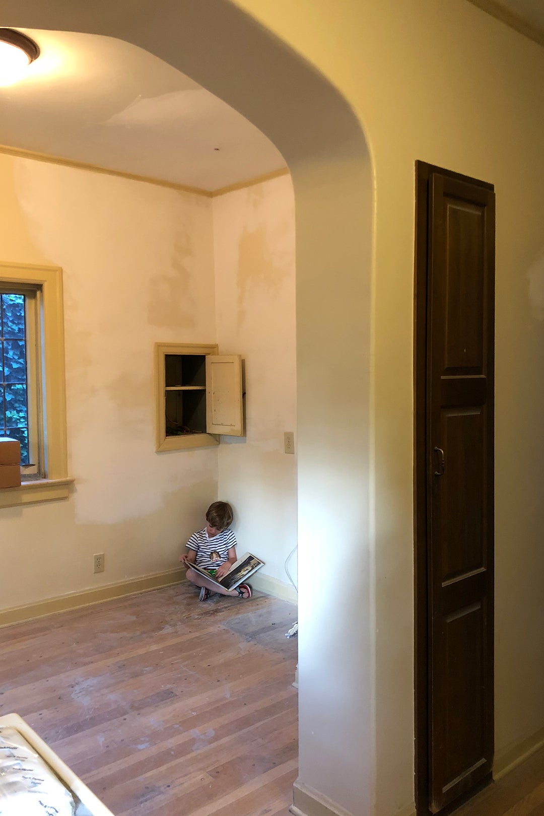 boy reading in unfinished room