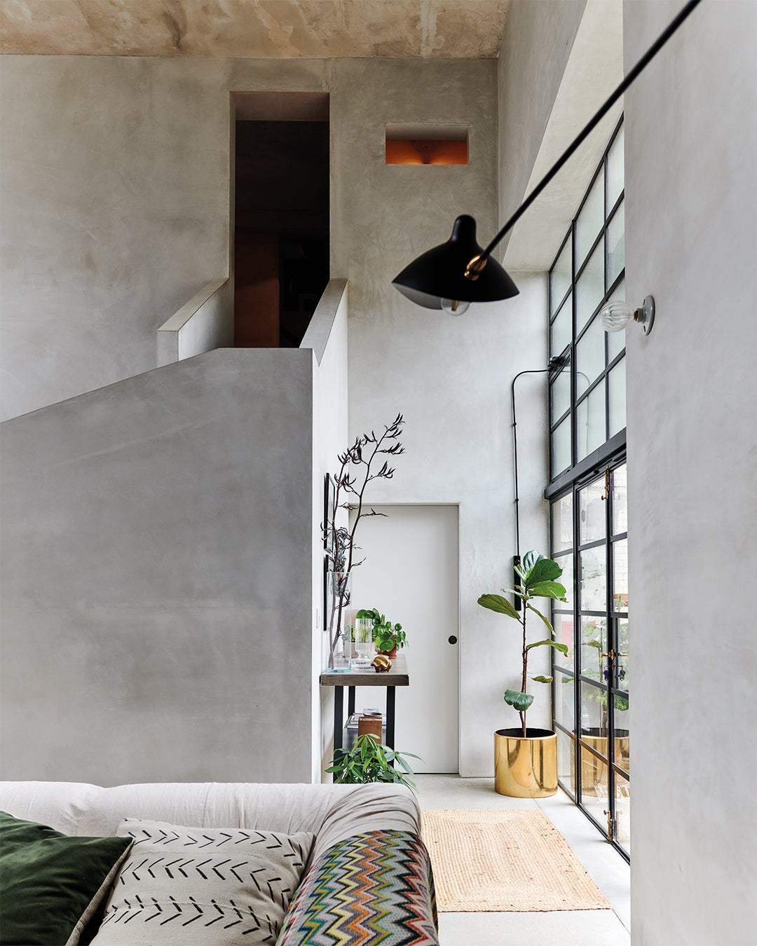 double-height room with gray plaster walls