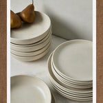 Stacks of neutral cream dinner plates