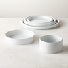 Low plates in shiny white porcelain rolled rims on plates, bowls, and