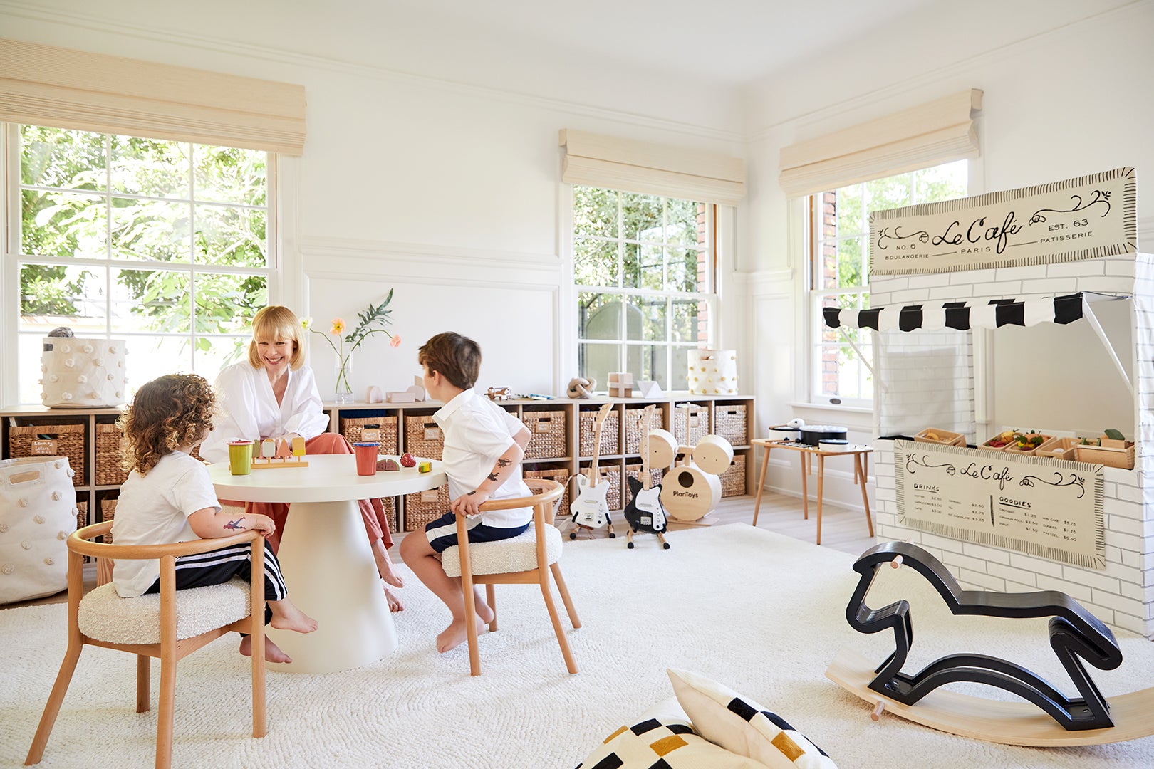 white, airy kids' playroom with play café