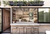 Open plan kitchen that leads to the outdoors with bar stools
