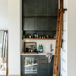 Black kitchen cabinets with a ladder