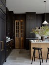Black kitchen cabinets with wooden doors