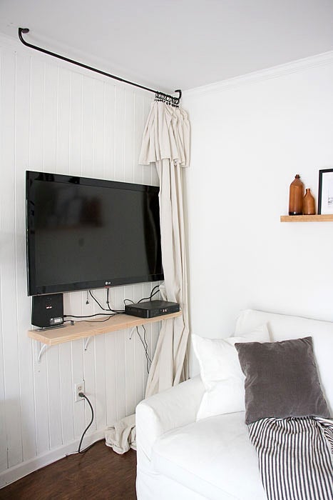 tv mounted on wall and gear on shelf