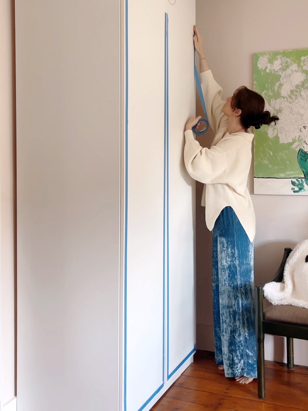woman putting tape on closet doors