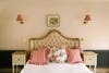 tufted bed with red pillows