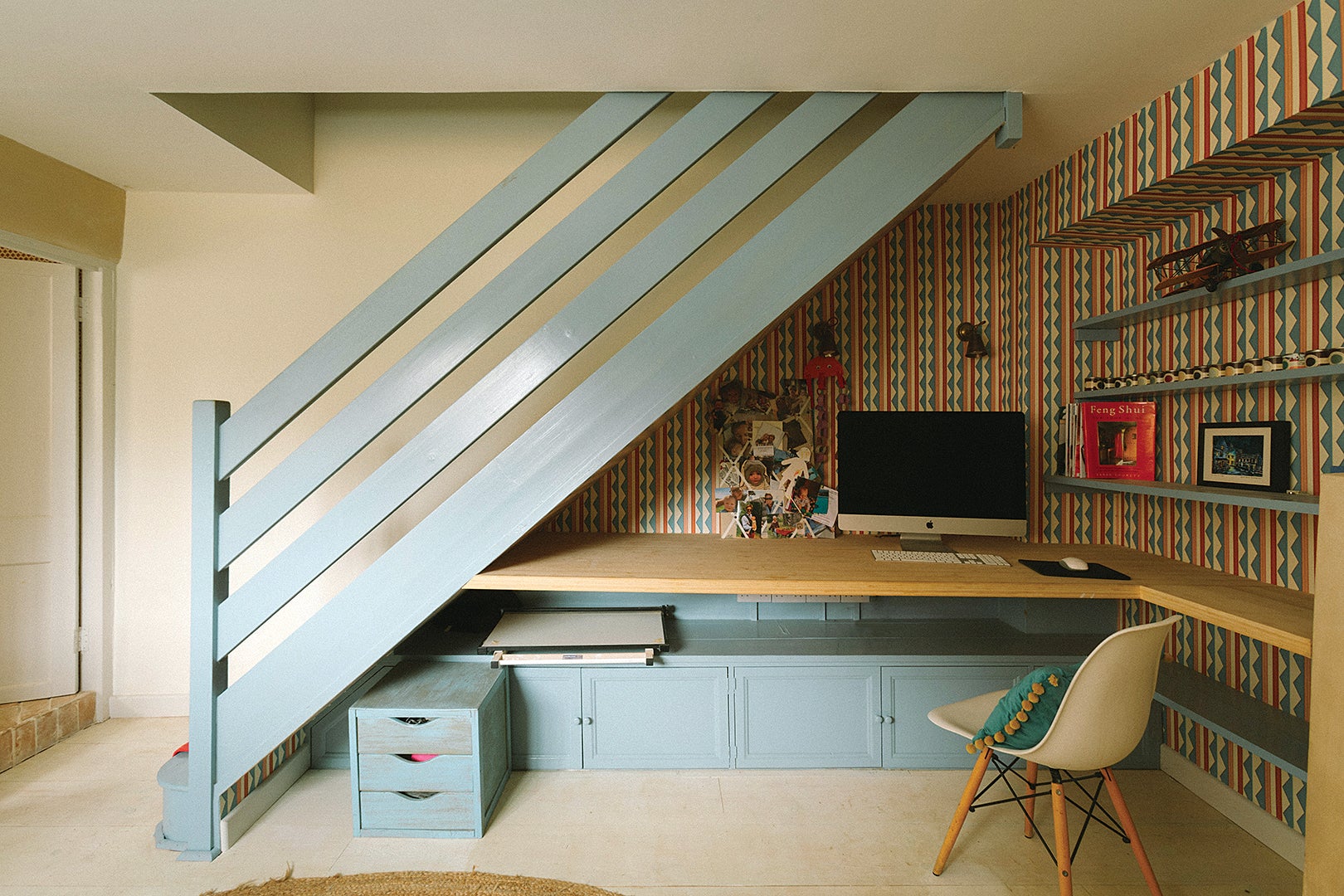 blue stairs with desk under