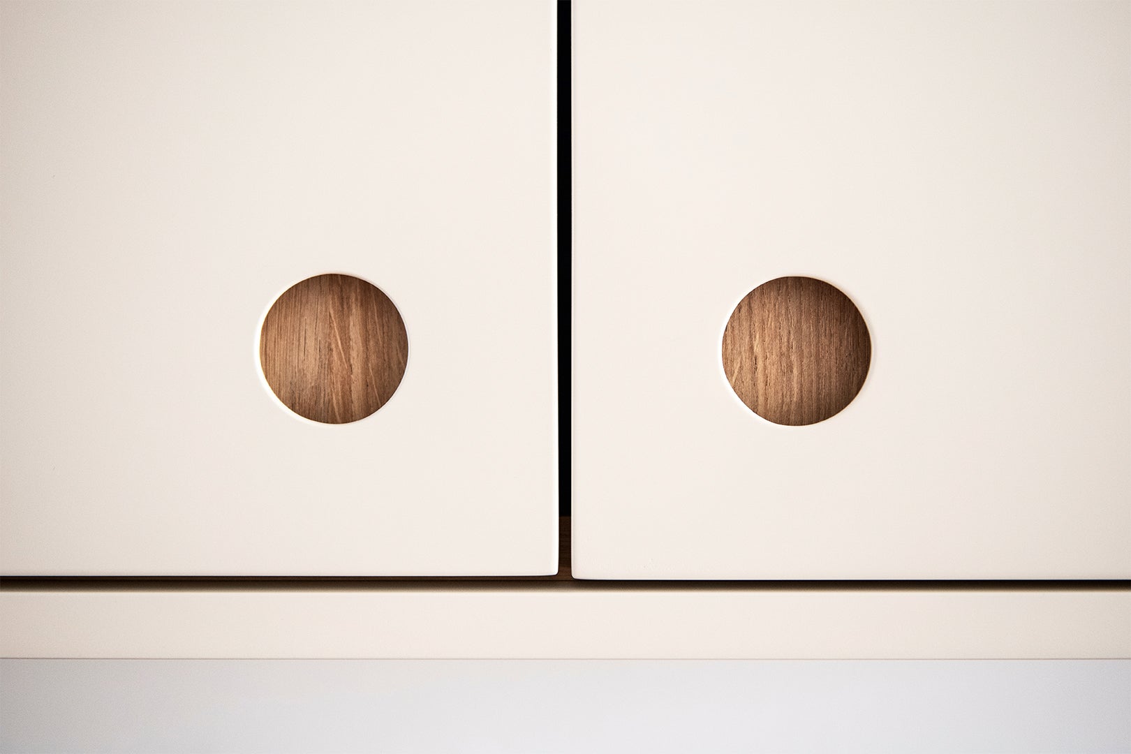 circular cutout finger pulls on cabinets