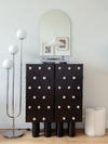 black cabinet with wood balls