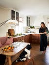 woman looking at dog in kitchen