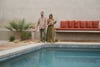 Couple with children standing near pool