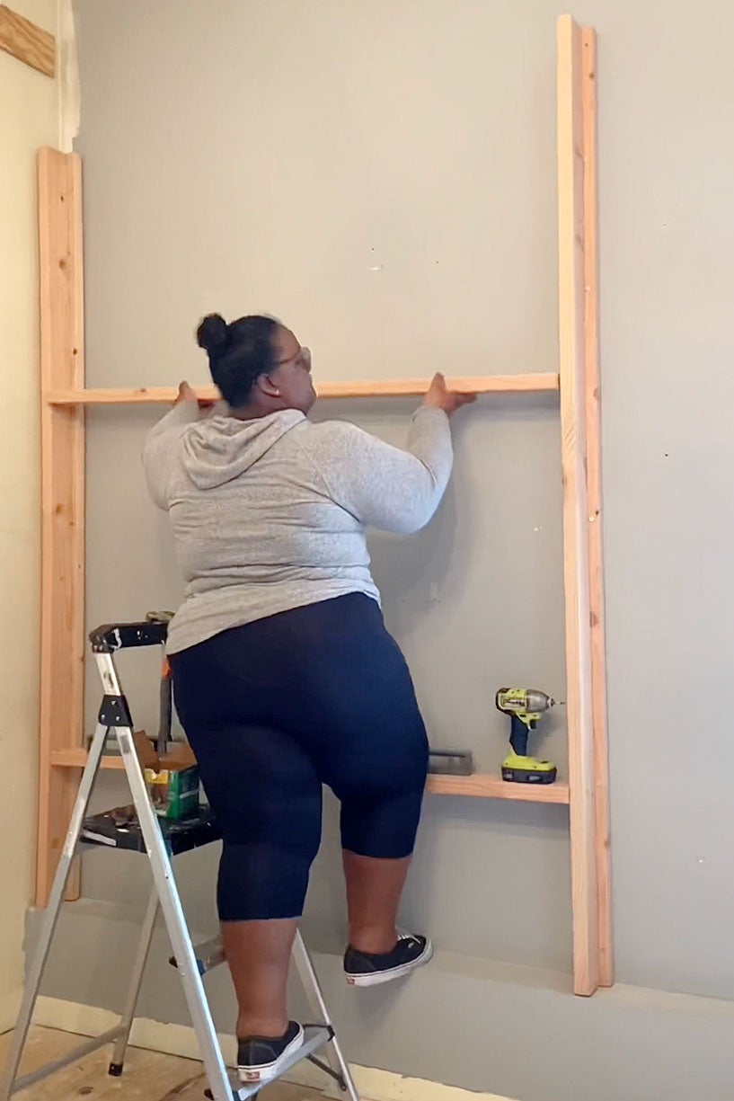woman installing framing