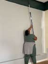 woman painting ceiling
