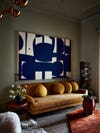 blue painting over sofa