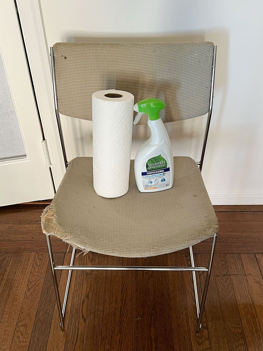 Chair with paper towel roll and cleaning solution on it