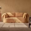 rounded sofa with draped back cushions