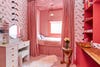 kid's room with pony wallpaper and red striped bed nook