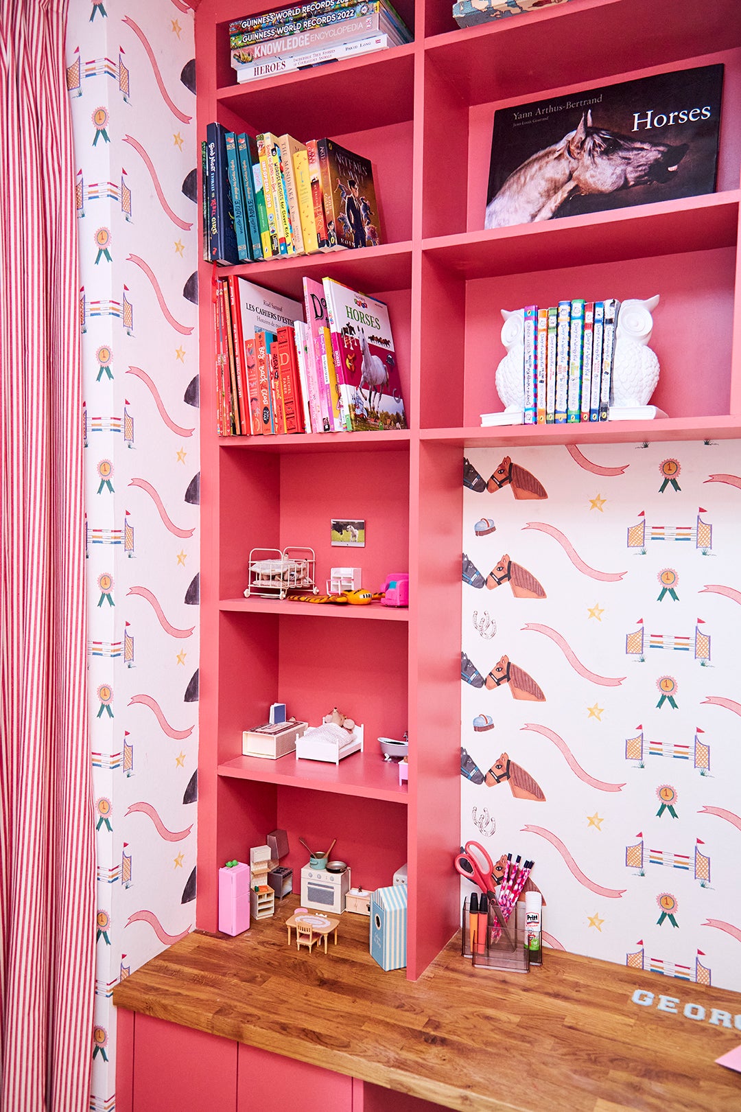 pink built-in shelves above desk